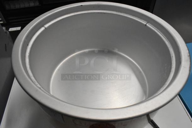 BRAND NEW RiceMaster Town 57138 rice cooker, 74 cup capacity, 230 volts, minor scratches, no dents visible.