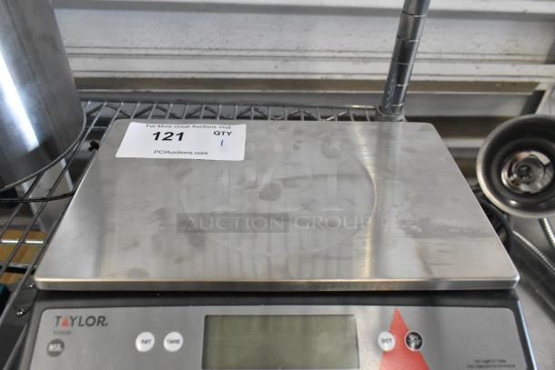 Brand new Taylor TE22OS digital scale, 22 lb. capacity, oversized platform, scratch and dent condition, with visible label.