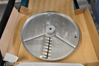 Brand new Robot Coupe 27621 5/64" ripple cut disc, visible scratch and dent, gray metallic finish, in box.