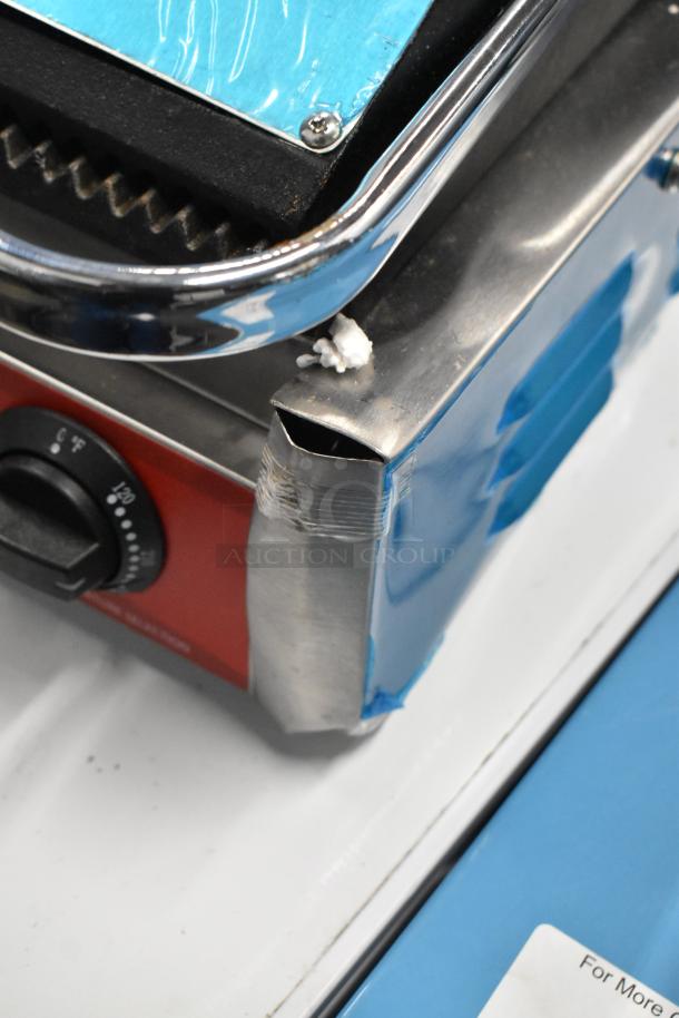 Brand new scratch and dent Avantco 177PG200 Panini Grill, grooved plates, 13 3/8" x 8 3/4" surface, 120V, 1 Phase.