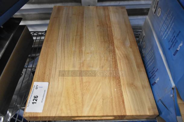 Brand new wooden cutting board with minor scratches and dents, natural wood grain, auction label visible.