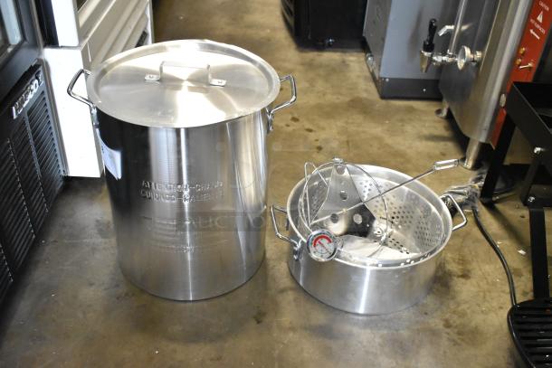 Brand new Backyard Pro metal pot for fryer, scratch and dent condition, includes lid, handles, and basket with thermometer.