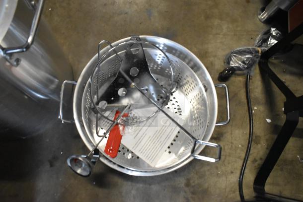 Brand new Backyard Pro metal fryer pot with basket, minor scratches and dents, includes handles and attachments.