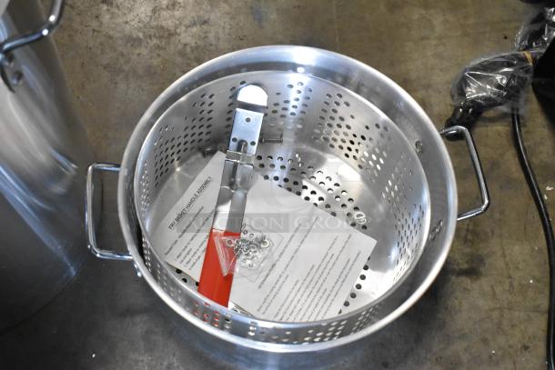 Brand new Backyard Pro metal fryer pot with assembly instructions. Slight scratches and dents visible.