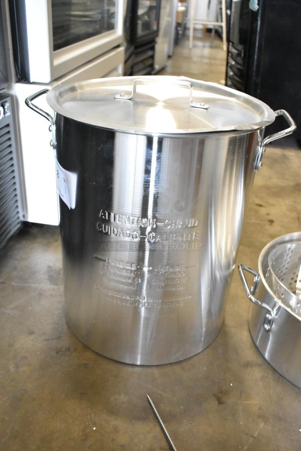 Brand new Backyard Pro metal fryer pot, scratch and dent condition, with lid and handles, embossed safety warnings visible.