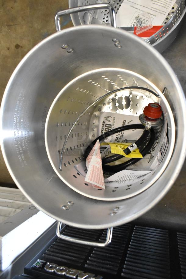 BRAND NEW SCRATCH AND DENT! Backyard Pro metal pot for fryer, includes handle and vented interior. Visible instructions and hose.