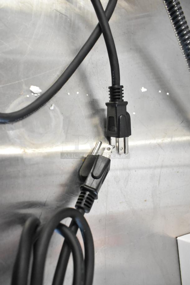 2 brand new scratch and dent metal heat lamps, models CK2514E008 and CK2510D237, with power cords shown.