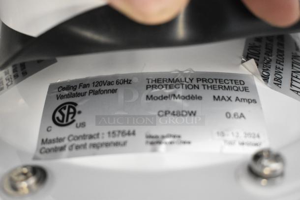 White Canarm CP48DW ceiling fan label, 120V, 0.6A, thermally protected, 7370 CFM, indoor/outdoor. Model info visible.