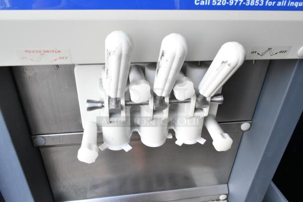 Alpine OP238EC 2 Flavor Soft Serve Ice Cream Machine, metal exterior, on commercial casters, power switch visible.
