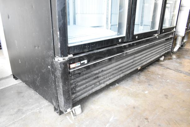 Turbo Air TGF-72SDB commercial 3-door cooler, metal exterior, poly-coated racks, visible wear, 115 volts, 1 phase.