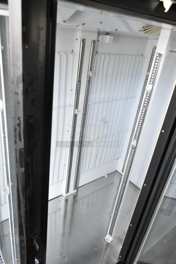 Turbo Air TGF-72SDB commercial 3-door cooler interior with poly-coated racks, showing metal construction and clean condition.