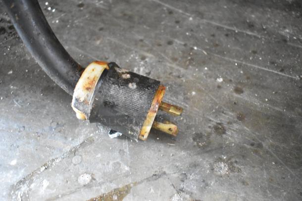 Close-up of a worn electrical plug for a Middleby Marshall CTX DZ33I pizza oven, showing visible rust and wear.