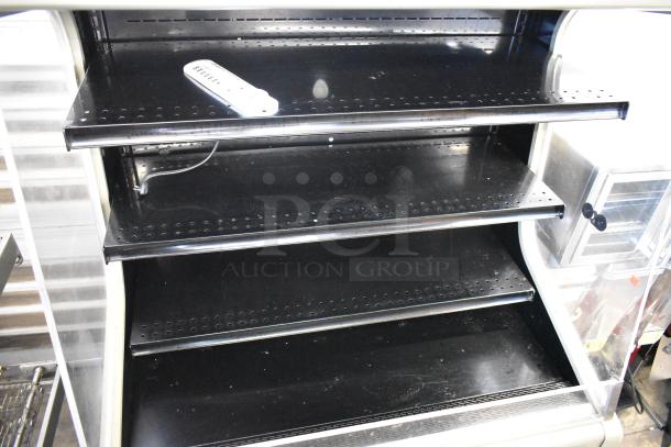 Hussmann GSVM-4060 commercial merchandiser with metal shelves, shown empty. 115 volts, 1 phase. Good condition.