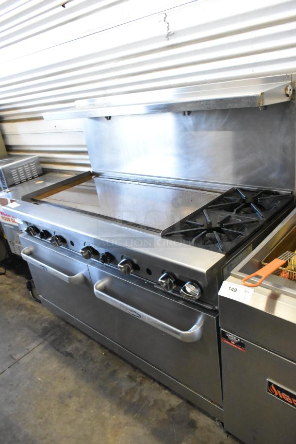 Cook Rite ATO-48G2B stainless steel flat top griddle with 2-burner range, 2 ovens, overshelf, backsplash, and casters.