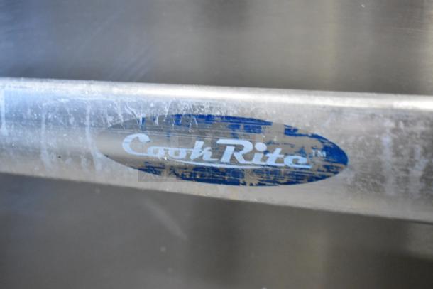 Cook Rite ATO-48G2B stainless steel logo on commercial kitchen griddle, slight wear visible.