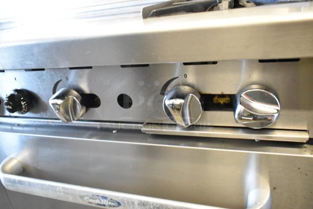 Cook Rite ATO-48G2B griddle with 2 burners, 2 ovens, stainless steel, back splash, and control knobs on commercial casters.