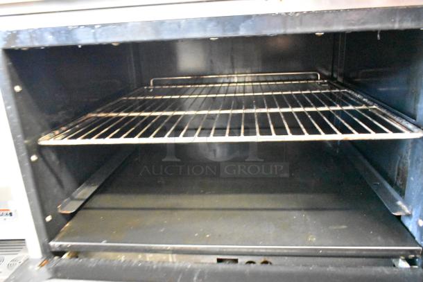 Cook Rite ATO-48G2B commercial oven interior, showing clean metal racks and spacious cooking area.