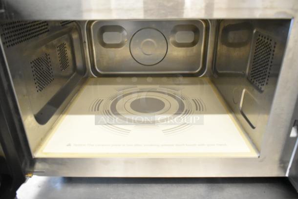 Spectrum EMW-1000SD commercial stainless steel microwave, 120V, 1 phase, clean interior with caution label on heating plate.