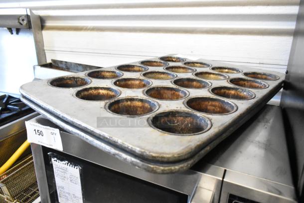 2 metal 20-cup muffin baking pans, used condition, visible wear. Auction lot 150 tag attached.