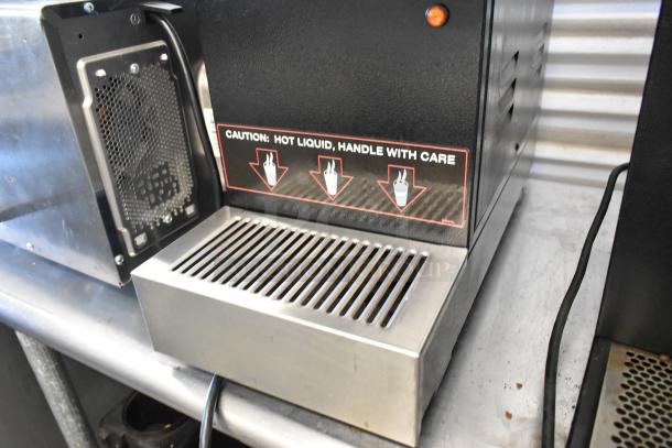 2016 Grindmaster GB3-K Commercial Cappuccino Machine, metal, with caution label. 120V, 1 Phase, countertop unit.