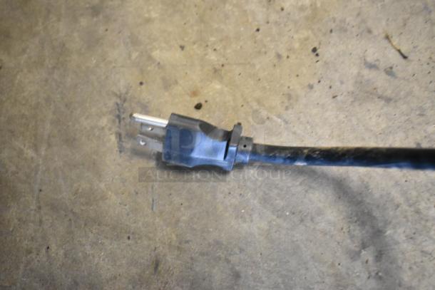 Power cord for 2016 Grindmaster GB3-K Commercial Cappuccino Machine, 120V, 1 Phase. Black with three-prong plug, shown on concrete.