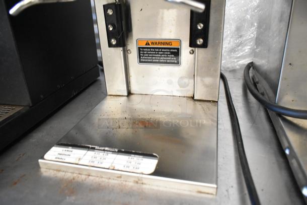 Bunn MHG stainless steel coffee bean grinder with two hoppers. Features electrical warning label, 120 volts, 1 phase.
