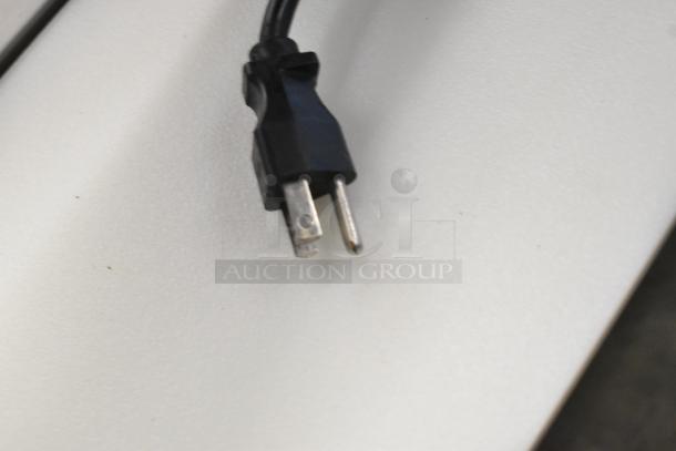 Bunn MHG coffee grinder power cord and plug on a white surface, showing a standard two-prong design.