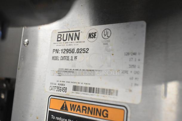 Bunn CWTF35 label showing model, serial number, and warning sticker on stainless steel commercial coffee machine.