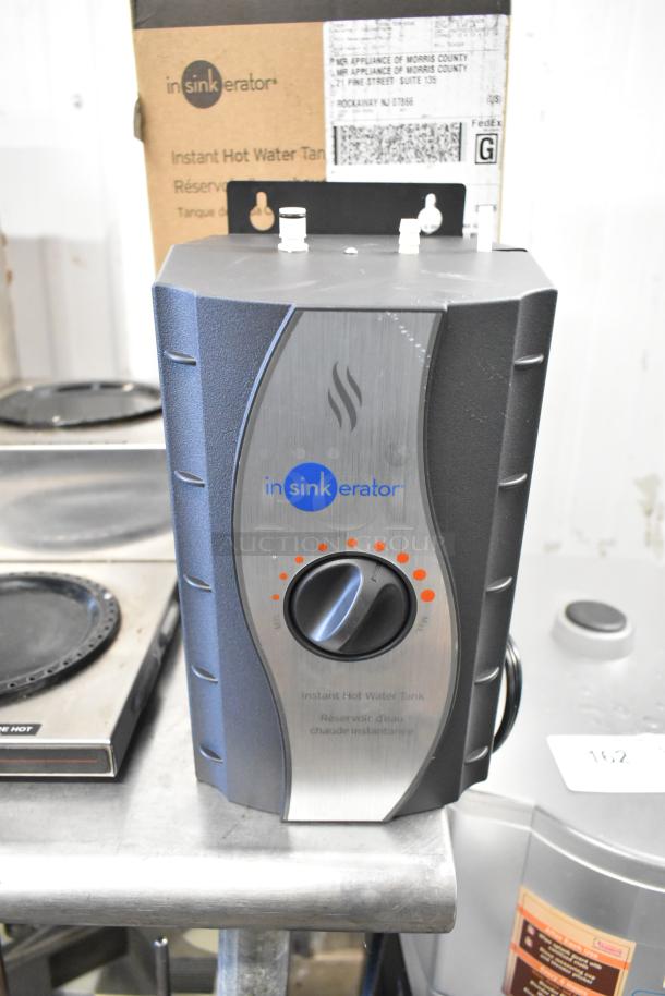 Insinkerator HWT Instant Hot Water Tank, black and silver design, temperature dial, excellent condition, original packaging visible.