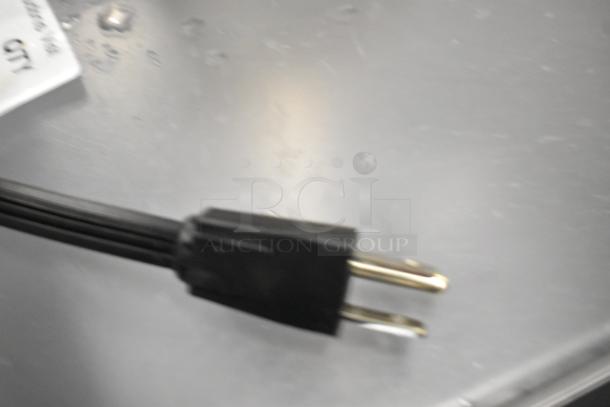 Insinkerator HWT Instant Hot Water Tank in silver, features visible power cord, showing slight wear, ideal for kitchens.