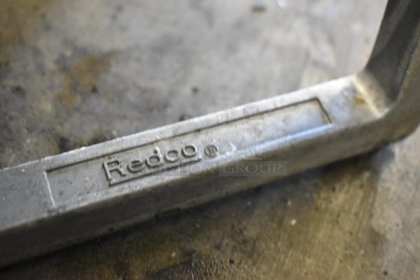 Redco Metal Countertop Vegetable Cutter showing embossed logo, indicating brand authenticity on metal surface.