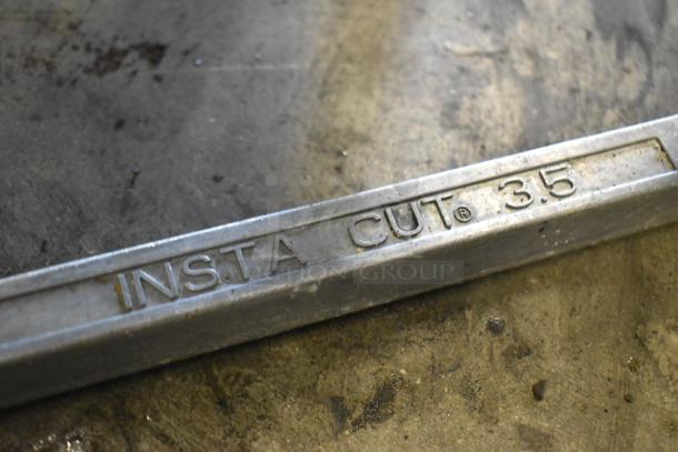 Redco Metal Countertop Vegetable Cutter with "Insta Cut 3.5" marking on metal frame, showing signs of wear.