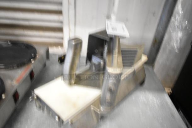 Nemco Metal Countertop Tomato Slicer, sturdy design, metal construction, used condition. Ideal for commercial kitchens.