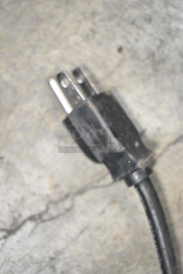 Close-up of a power plug from a Taylor X83684-12 Metal Commercial Countertop Frozen Drink Mixing Station.