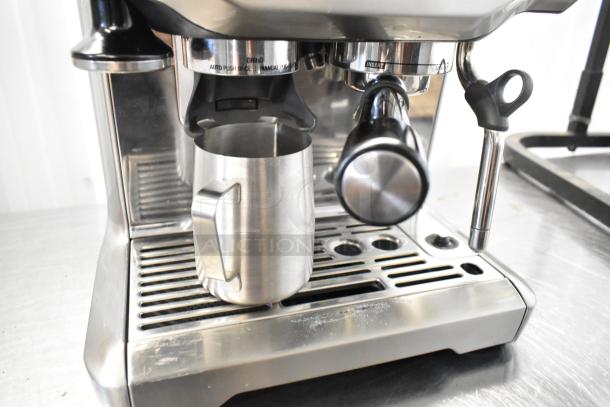 Breville metal countertop single group espresso machine with bean hopper and portafilter, featuring a stainless steel design.