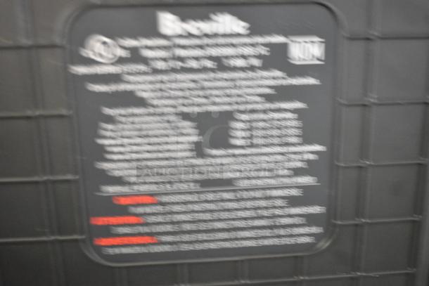 Blurry label of Breville metal countertop single group espresso machine. Contains technical and safety information.