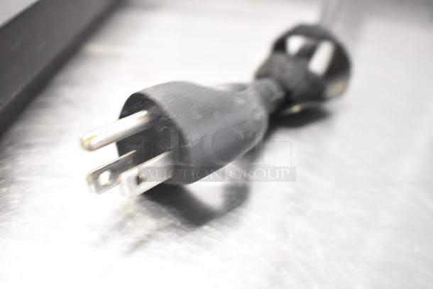 Close-up of a power cord for a Breville Metal Countertop Single Group Espresso Machine, highlighting plug details.