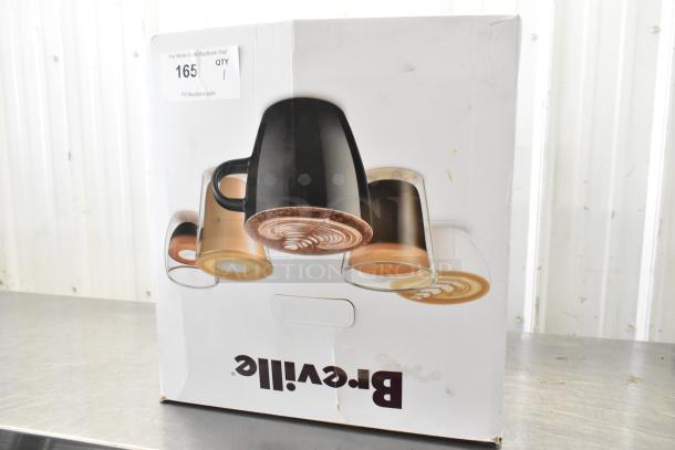 Breville espresso machine in original box, featuring imagery of coffee cups. Box shows slight wear; item includes bean hopper and portafilter.