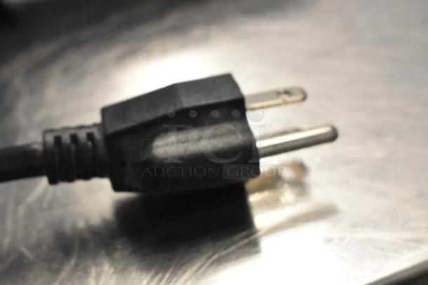 Close-up of the plug for the 2020 KX0045 Metal Commercial Countertop 2 Head Heat Lamp, 120 volts, 1 phase.