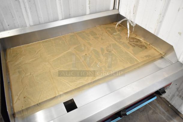 2024 Avantco 177CAG36MG stainless steel commercial griddle, natural gas, flat top, new condition with protective covering.