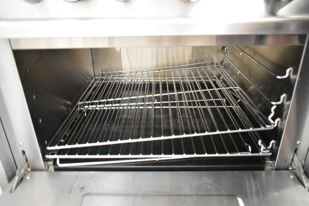 2024 Hangzhou stainless steel commercial gas 6-burner range with oven, over shelf, and backsplash on casters. Interior oven view.