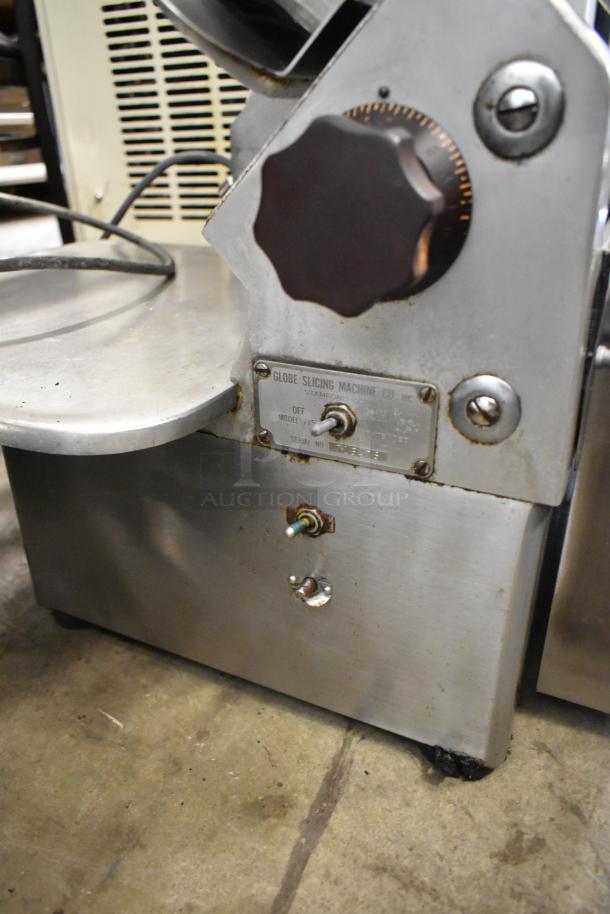 Globe 715 metal commercial meat slicer with blade sharpener, model 715, 115 volts, visible dial and serial tag.