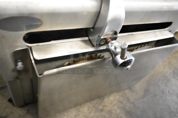 Globe 715 metal commercial countertop meat slicer with blade sharpener, showing metal components and adjustment knob.