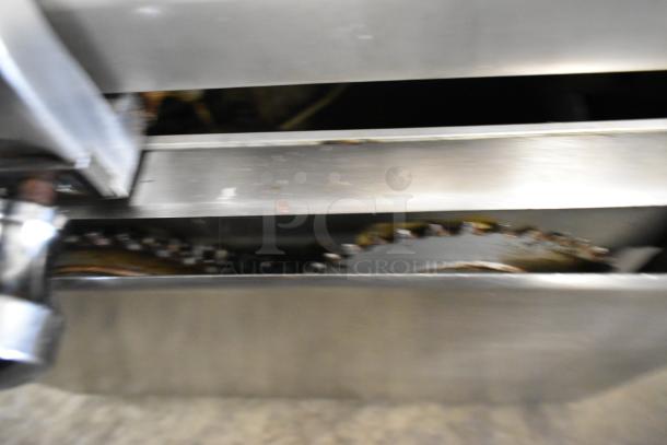 Globe 715 metal meat slicer with blade sharpener, 115V, 1 phase. Close-up of internal gears and blade mechanism.