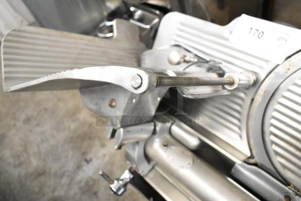 Globe 715 metal meat slicer with blade sharpener, 115 volts, 1 phase, in used condition, model number visible in image.