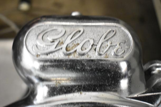 Globe 715 metal commercial countertop meat slicer with blade sharpener, 115 volts, 1 phase. Brand logo visible.