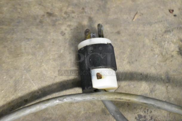 Close-up image of a power plug for the Globe 715 meat slicer, showing wear on the cable.