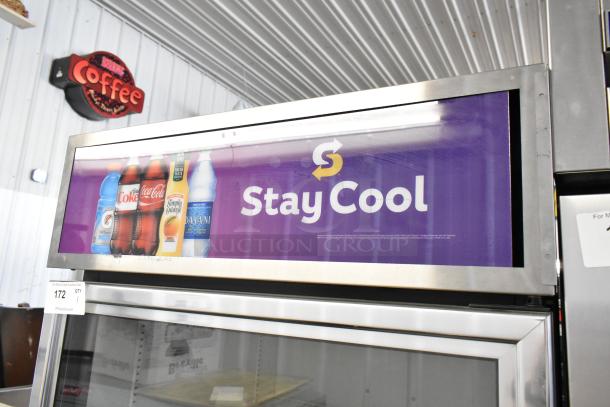 2018 True GDM-26-HC metal single-door reach-in cooler with poly-coated racks, advertising panel reads "Stay Cool".