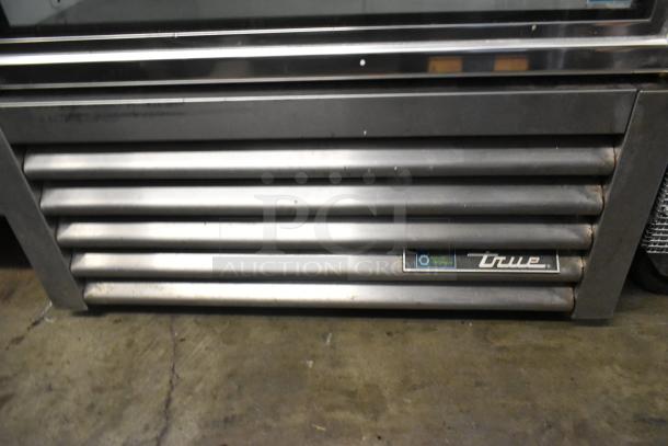 2018 True GDM-26-HC metal commercial cooler with single glass door, poly-coated racks, 115 volts, and logo visible on grille.