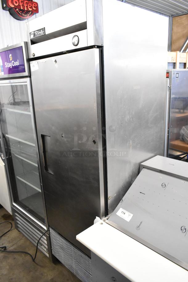 True T-23F stainless steel commercial freezer, single door, on casters. Features True branding and temperature gauge.